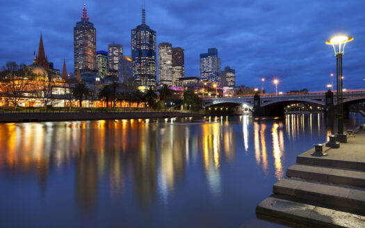 A city view of commercial real estate in Melbourne at night