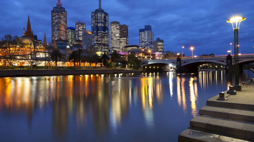 A city view of commercial real estate in Melbourne at night