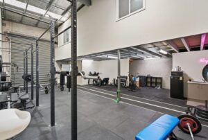 High-clearance roller door and functional interior of industrial real estate for sale in Airport West