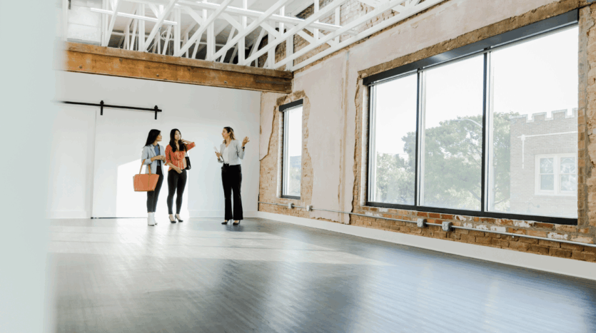 Commercial property inspection with prospective buyers and agent, illustrating a going concern sale.