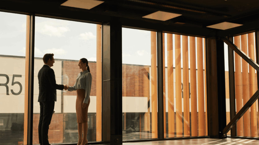 Commercial property deal with two professionals shaking hands, representing a going concern sale.