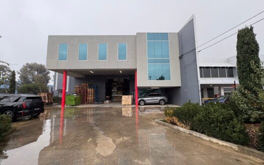 Industrial warehouse for lease at 17 Ovata Drive Tullamarine featuring covered loading area and modern office frontage